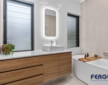 Residential Bathroom Design featuring a meticulously crafted vanity cabinet with sink & mirror & bathtub by Fergus Builders Residential, Industrial & Commercial real estate development Mackay