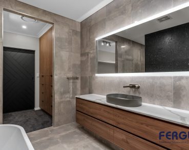 Residential Bathroom Design featuring a meticulously crafted vanity cabinet with sink & mirror & bathtub by Fergus Builders Residential, Industrial & Commercial real estate development Mackay