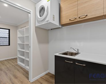 Residential Laundry Room with sink & built in cabinets design by Fergus Builders Real estate Development Mackay