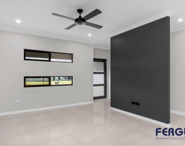 Residential Indoor Living Area design highlighted by a fixed window and a thoughtfully crafted built-in partition wall by Fergus Builders Real Estate development Mackay