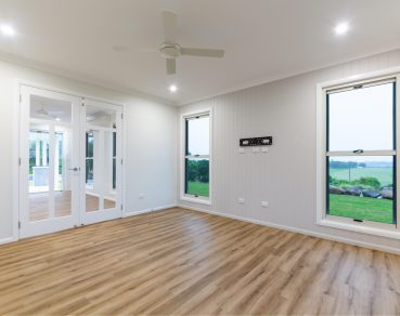 Residential Indoor Living Area adorned with a sophisticated tilt-and-turn window and a seamlessly integrated french door by Fergus Builders Residential, Industrial & Commercial real estate development Mackay