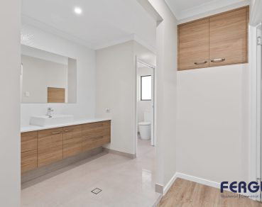 Residential Bathroom Design featuring a meticulously crafted vanity cabinet with sink & mirror by Fergus Builders Residential, Industrial & Commercial real estate development Mackay